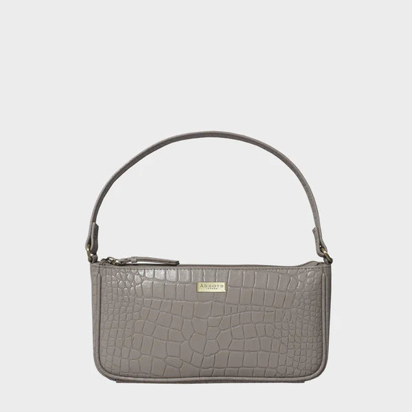 Croc-embossed genuine leather baguette shoulder bag with slim profile and top zipper closure.