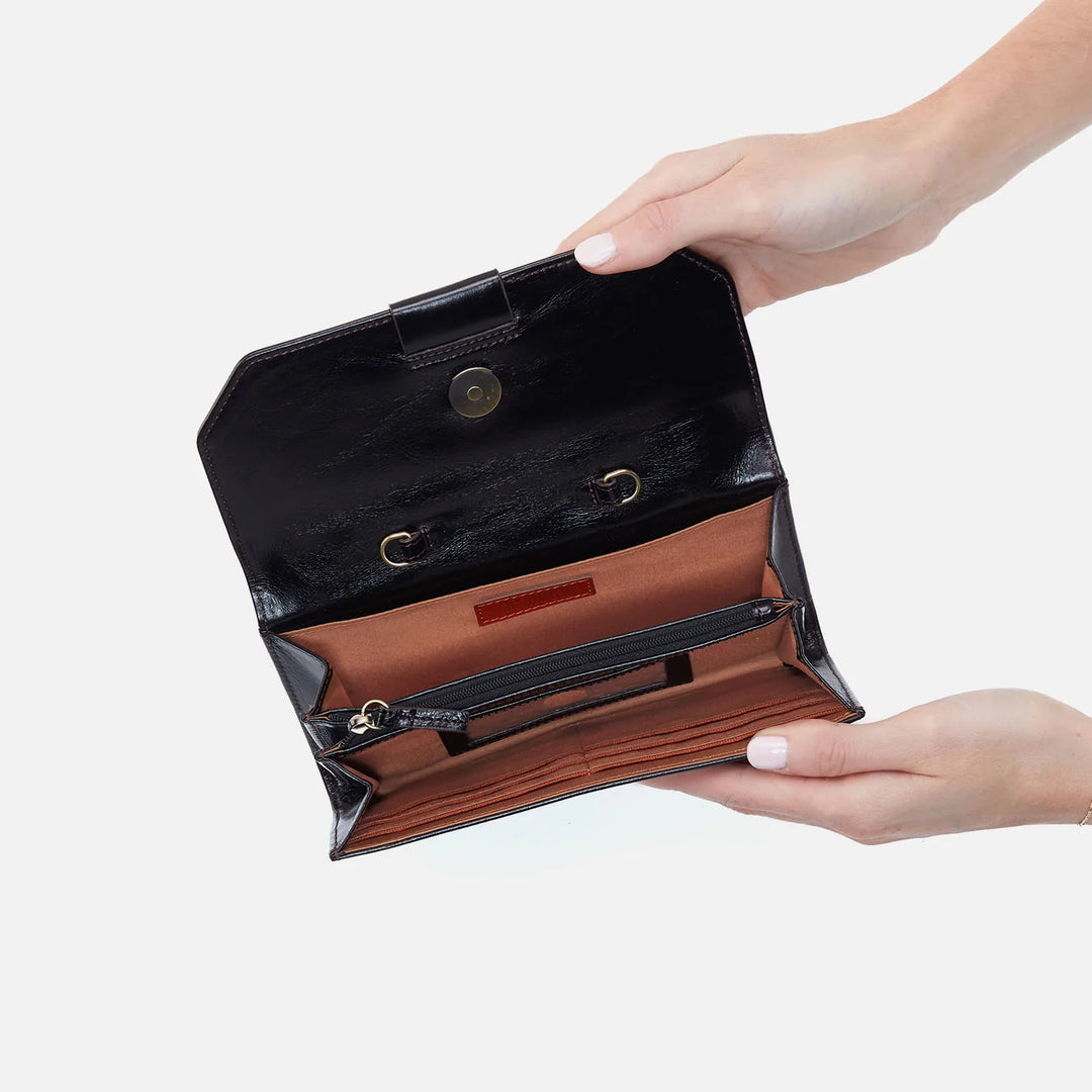 Model wearing the Romy Wallet Crossbody across the body, styled with a neutral outfit to highlight its versatility and size.