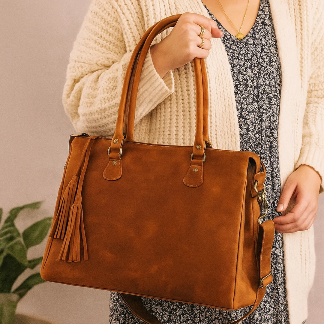 Model carrying large saddle brown handbag – full-grain leather tote by Hides