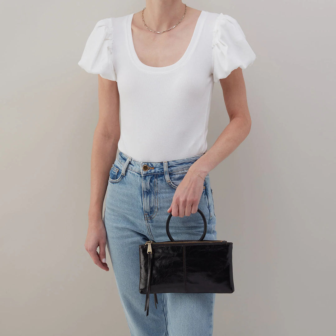 Model wearing HOBO Sable Crossbody in black, styled crossbody