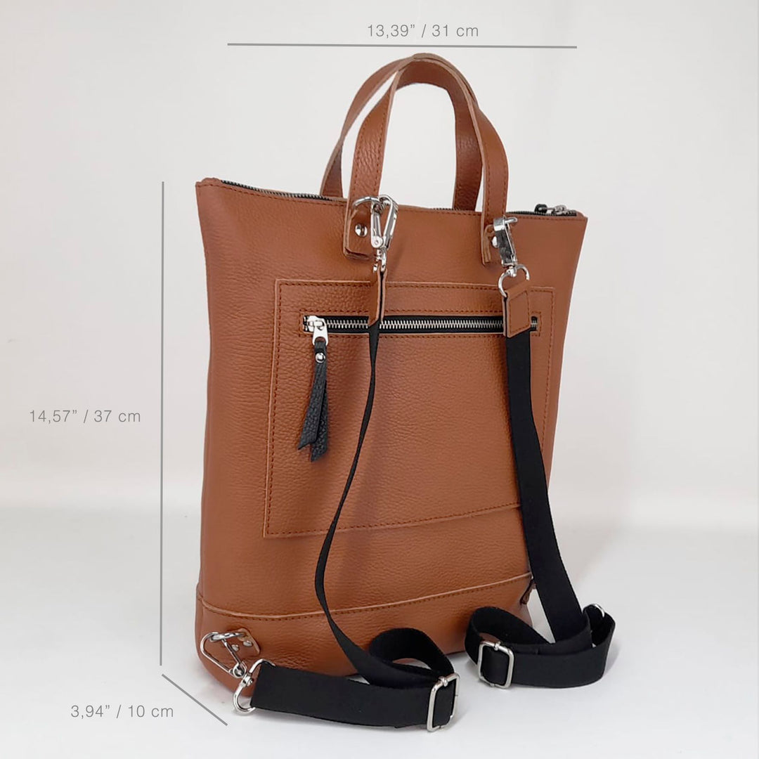 Side view of brown leather convertible tote backpack with adjustable straps and stitching detail