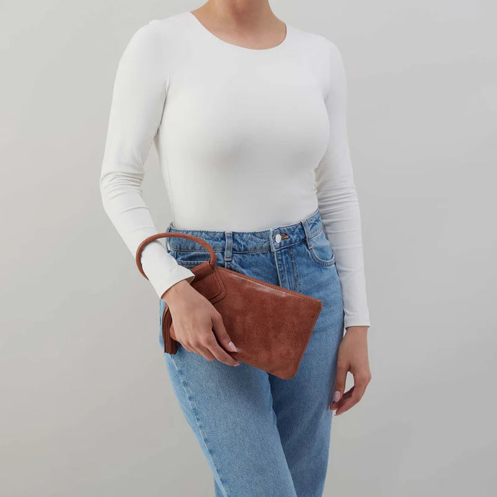 Angled view of HOBO Sable Wristlet showing circular leather strap and buffed finish