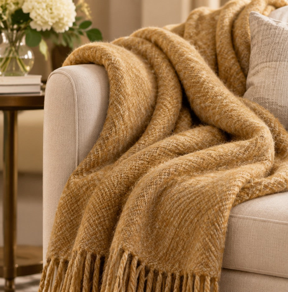 Camel gold alpaca throw on an elegant ivory chair