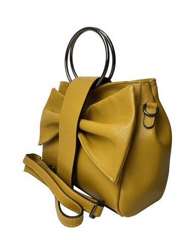 Side view of Italian leather handbag by Fior di Loto showing structured silhouette and circular handbag handles.